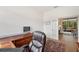 Well-appointed home office with hardwood floors and ample natural light streaming from a nearby window at 6212 Nimes Ct, Lutz, FL 33558