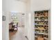 Walk-in pantry with decorative wallpaper, wood shelving and ample storage space at 6212 Nimes Ct, Lutz, FL 33558