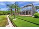 Screened-in pool surrounded by manicured artificial turf and lush landscaping at 6212 Nimes Ct, Lutz, FL 33558