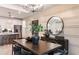 Elegant dining room with a large dark table set with black chairs, complemented by modern decor and fixtures at 6811 Jared Oaks Dr, Wesley Chapel, FL 33545