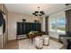 Stylish home office with modern lighting, decorative art, and view of the front yard at 6811 Jared Oaks Dr, Wesley Chapel, FL 33545