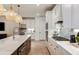 Well-appointed kitchen boasts stainless steel appliances, sleek countertops, and designer pendant lighting at 6811 Jared Oaks Dr, Wesley Chapel, FL 33545