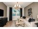 Relaxing living room with lake view, stylish lighting fixture, modern sofa and decorative art at 6811 Jared Oaks Dr, Wesley Chapel, FL 33545
