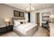 Luxurious main bedroom featuring elegant furnishings, soft lighting, and a door to an ensuite bathroom at 6811 Jared Oaks Dr, Wesley Chapel, FL 33545