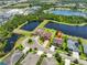 Overhead view of home in community with lake view, mature trees and nearby shopping at 6913 Park Strand Dr, Apollo Beach, FL 33572
