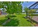This backyard offers a serene lake view, lush lawn, and a screened-in patio, perfect for relaxation and outdoor activities at 6913 Park Strand Dr, Apollo Beach, FL 33572