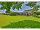 Spacious backyard with lush lawn, lake view, and screened-in patio perfect for outdoor entertaining and relaxation at 6913 Park Strand Dr, Apollo Beach, FL 33572