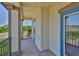 Balcony with stone accents, covered ceiling, and railing at 6913 Park Strand Dr, Apollo Beach, FL 33572