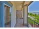 Balcony with stone accents, covered ceiling, and railing at 6913 Park Strand Dr, Apollo Beach, FL 33572