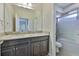 Bathroom with granite countertops, dark cabinets, and a shower/tub combo at 6913 Park Strand Dr, Apollo Beach, FL 33572