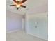 Bedroom with ceiling fan, double door closet, and door to adjacent room at 6913 Park Strand Dr, Apollo Beach, FL 33572