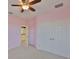 View of bedroom with double door closet, adjacent room, and window at 6913 Park Strand Dr, Apollo Beach, FL 33572