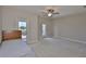 Bright bedroom featuring a ceiling fan, neutral walls, carpeted floors and a balcony at 6913 Park Strand Dr, Apollo Beach, FL 33572