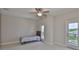 Bright bedroom featuring a ceiling fan, neutral walls, carpeted floors and a balcony at 6913 Park Strand Dr, Apollo Beach, FL 33572