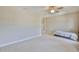 Bright bedroom featuring a ceiling fan, neutral walls, carpeted floors and a balcony at 6913 Park Strand Dr, Apollo Beach, FL 33572
