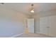 A bedroom with carpeted floors, closet doors, and modern lighting at 6913 Park Strand Dr, Apollo Beach, FL 33572