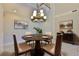 Elegant dining room with a round table, stylish chairs, and artwork, great for entertaining at 6913 Park Strand Dr, Apollo Beach, FL 33572