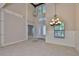 Spacious foyer with a high ceiling, chandelier, and tiled floor, leading to other rooms at 6913 Park Strand Dr, Apollo Beach, FL 33572