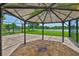 Relax at the gazebo situated on the brick paver patio with views of the lake and backyard at 6913 Park Strand Dr, Apollo Beach, FL 33572