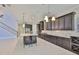 Open kitchen features granite countertops, stainless steel appliances, and dark cabinets at 6913 Park Strand Dr, Apollo Beach, FL 33572