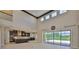 Open concept living room boasts high ceilings and backyard views at 6913 Park Strand Dr, Apollo Beach, FL 33572