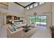 Bright living room features high ceilings, fireplace, and sliding glass doors at 6913 Park Strand Dr, Apollo Beach, FL 33572