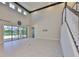 A light-filled living room with high ceilings, and tile flooring has backyard and patio access at 6913 Park Strand Dr, Apollo Beach, FL 33572