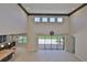 A bright, spacious living room showcases soaring ceilings, large windows and glass doors leading to an outdoor living space at 6913 Park Strand Dr, Apollo Beach, FL 33572