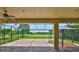 The covered outdoor patio features a screened in enclosure, gazebo, ceiling fan, and backyard lake views at 6913 Park Strand Dr, Apollo Beach, FL 33572