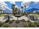 Community picnic area with barbecue grills, tables, seating, and lush landscaping at 6913 Park Strand Dr, Apollo Beach, FL 33572