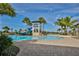 Inviting community pool area with a water slide, tower, and palm trees at 6913 Park Strand Dr, Apollo Beach, FL 33572