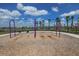 Colorful swing set in a playground with views of the lake and swaying palm trees at 6913 Park Strand Dr, Apollo Beach, FL 33572