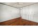 Bedroom with wood floors and white closet doors offering ample storage at 7701 Starkey Rd # 504, Seminole, FL 33777