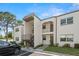 Charming condominium with a landscaped entrance, and a black car parked nearby at 7701 Starkey Rd # 504, Seminole, FL 33777