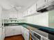 Well-lit kitchen features white cabinets, stainless steel appliances, and durable countertops at 7701 Starkey Rd # 504, Seminole, FL 33777