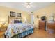 Bright bedroom featuring a queen bed, dark dresser, and colorful bedspread at 7701 Starkey Rd # 601, Seminole, FL 33777