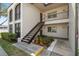 Condo exterior featuring a private entrance with stairs and well-maintained landscaping at 7701 Starkey Rd # 601, Seminole, FL 33777