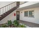 Condo exterior featuring a private entrance with stairs and well-maintained landscaping at 7701 Starkey Rd # 601, Seminole, FL 33777