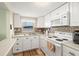 Updated kitchen with white cabinets, tile backsplash, and stainless steel appliances at 7701 Starkey Rd # 601, Seminole, FL 33777