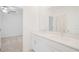 Bathroom featuring double sinks, quartz countertop, and large mirror at 7703 S Kissimmee St, Tampa, FL 33616