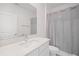 Bathroom featuring a single vanity with a quartz countertop and shower with curtain at 7703 S Kissimmee St, Tampa, FL 33616
