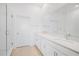 Modern bathroom featuring a double vanity, quartz countertop, and a glass enclosed shower at 7703 S Kissimmee St, Tampa, FL 33616