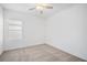Bright bedroom features neutral carpet, one window, and a ceiling fan at 7703 S Kissimmee St, Tampa, FL 33616