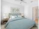 Stylishly decorated bedroom with a plush bed, side tables, and coastal wall art at 7703 S Kissimmee St, Tampa, FL 33616