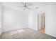 Spacious bedroom features neutral carpet, a ceiling fan, and natural light at 7703 S Kissimmee St, Tampa, FL 33616