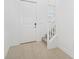 Bright entryway featuring tiled floors, white trim, and a staircase leading to the upper level at 7703 S Kissimmee St, Tampa, FL 33616