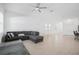 Spacious living area features tile floors and neutral decor, creating a bright and airy space at 7703 S Kissimmee St, Tampa, FL 33616