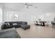 Open-concept living and dining area with tile floors and modern decor offers an inviting atmosphere at 7703 S Kissimmee St, Tampa, FL 33616