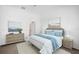Comfortable primary bedroom featuring stylish decor, plush bedding, and a serene ambiance at 7703 S Kissimmee St, Tampa, FL 33616