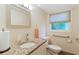 Bright bathroom featuring granite countertop, modern sink, and ample natural light from the window at 8350 40Th N Ave, St Petersburg, FL 33709